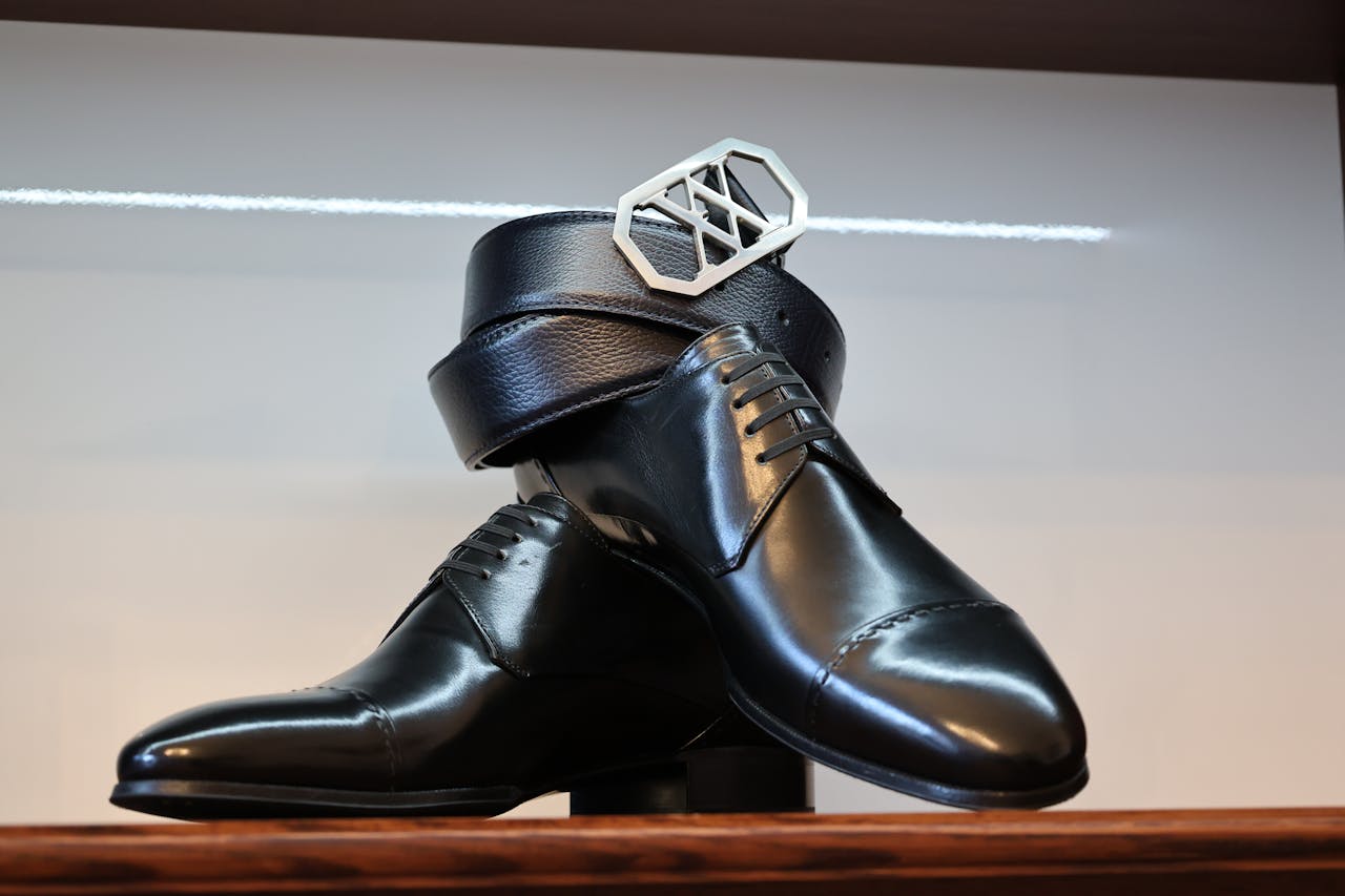 Classic black leather shoes paired with a matching belt in a stylish arrangement.